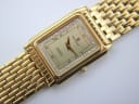 Close-up of the Sandoz champagne dial, showing "Swiss ETA Quartz" text, gold hands, and the rhinestone-set bezel.
