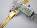 Digital caliper measuring the Sandoz watch case diameter at 24.37mm.