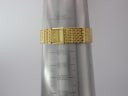 Sandoz gold-tone bracelet on a wrist sizing cone, showing a circumference measurement of approximately 183mm.