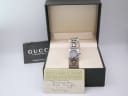 The Gucci 6400 L watch with its original green Gucci presentation box and authenticity papers, including a hand-written purchase date of 11-11-99.