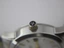 Macro shot of the gold-tone crown with the distinct Dreyfuss & Co. emblem.