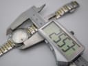 Digital caliper measuring the Dreyfuss & Co. watch case diameter at 25.57mm.