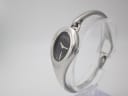 Angled side view of the Gucci 103 watch, showcasing the sleek silver case and integrated bangle design.