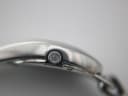 Macro shot of the Gucci 103 watch crown, featuring a subtle engraved 'G' logo.