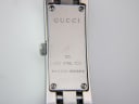 Close-up of the watch case back, showing 'GUCCI', '110', 'STEEL', 'GUCCI SWISS®', and serial number 11658378.
