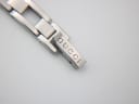 Close-up of the signed folding clasp on the Gucci stainless steel bracelet, showing the 'GUCCI' engraving.