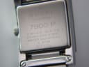 Detailed close-up of the watch case back, showing "GUCCI timepieces", "7900 P", "SWISS MADE", "STAINLESS STEEL", "WATER RESISTANT 3 ATM", and serial number "0021594".