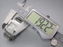 Digital caliper measuring the case diameter of the Gucci watch, displaying a precise reading of 19.22mm.