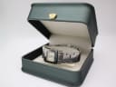 The Gucci 7900 P watch presented within a generic green leatherette display box with a gold crown emblem.