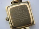 Close-up of the watch's case back, clearly engraved with "GUCCI 1900 L", "SWISS MADE", "STAINLESS STEEL", "SAPPHIRE CRYSTAL", "WATER RESISTANT 3 ATM", and serial number "0243519".