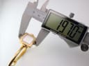 Digital caliper measuring the case diameter of the Gucci 1900 L, displaying a precise reading of 19.70 mm.