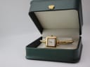 The Gucci 1900 L watch resting inside a generic green presentation box with a gold crown emblem.