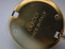 Close-up of the watch case back, showing engraved text that reads "GUCCI MADE IN ITALY".