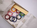 The interior of the original Gucci box, revealing the assortment of 12 colourful interchangeable bezels and the product tag.