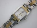 Close-up of the white dial with Tissot 1853 logo, gold-tone '2' and '6' numerals, and matching hands.