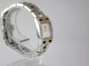 Another angled side view of the Tissot watch on a clear stand, highlighting the integrated bracelet design.