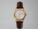 Front view of Tissot T031210 A quartz watch with gold tone case, silver dial, Roman numerals, and brown leather strap.