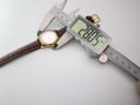 Digital caliper measuring the case diameter of the Tissot T031210 A watch at 28.05mm.