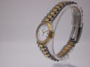 Side profile view of the Tissot Seastar D 311, highlighting the gold-plated bezel, crown, and integrated two-tone bracelet.
