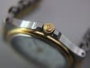 Close-up of the gold-plated crown, clearly displaying the iconic Tissot 'T' logo.