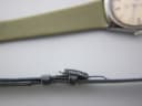 Close-up of the original Certina signed buckle, silver-toned, detached from the strap.