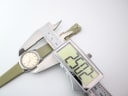 Digital caliper measuring the case diameter of the Certina Club 2000, displaying 25.07mm.