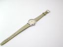 Full length view of the Certina Club 2000 watch, showcasing its green leather strap on a white background.