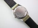 Close-up of the watch case back, revealing the serial number 824 3874 41 engraved into the brushed metal.