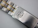 Close-up of the two-tone stainless steel bracelet clasp, featuring the Tissot logo.