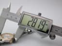 Digital caliper measuring the case diameter of the Tissot PR 50 watch, showing a reading of 28.19 mm.