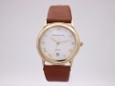 Front view of Mappin & Webb gold tone quartz watch with white dial and roman numerals.