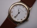 Close-up of the Mappin & Webb white dial with gold roman numerals, "Swiss Made" and date window.
