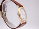 Side view of the Mappin & Webb watch showing the polished gold tone case profile.