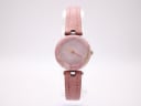 Front view of Tissot RockWatch R140 with pink stone dial, yellow and red hands, and pink leather strap on white background.