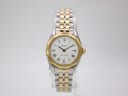 Front view of Tissot PR 100 ladies watch with two-tone bracelet and white dial with Roman numerals.