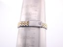 Tissot PR 100 bracelet on a wrist sizing cone, indicating a wrist circumference of 150mm / 15cm.