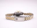 View of the two-tone stainless steel bracelet with a signed fold-over clasp.
