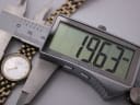 Digital caliper measuring the Tissot watch case diameter at 19.63mm, with the watch dial clearly visible on the left.