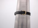 Watch on a wrist sizing cone, showing the black leather strap buckled at approximately 160mm