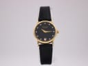 Full front view of Raymond Weil 9923 watch on a clear stand, showing black dial, gold case, and black leather strap