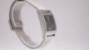 Other side view of the GUCCI 7700L watch on a display stand, showing the curved profile of the case.
