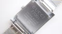 Close-up of the polished stainless steel case back of the GUCCI 7700L, with engravings 'GUCCI 7700L', 'SWISS MADE', 'STAINLESS STEEL', 'WATER RESISTANT 3 ATM', and serial number '0036235'.