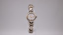 Front view of the Bulova ladies' two-tone quartz watch with integrated bracelet and white dial.