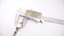 Digital caliper measuring the Bulova watch case diameter at 18.82mm.