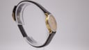 Angled side view of the Tissot C226K watch, highlighting the watch's slim profile, two-tone case and brown leather strap.