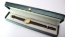 The Tissot C226K watch with its brown leather strap presented open in a generic green leatherette display box.