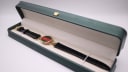 The Gucci 6000.2.L watch presented in a green leatherette display box.