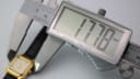 Digital caliper measuring the Bulova watch case diameter at 17.78mm, showing the side profile.
