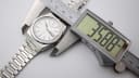 Digital caliper measuring the Seiko watch case diameter at 35.88mm.