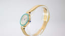 Side profile view of the Yema watch, showing the elegant case, turquoise bezel, and the blue cabochon crown.
